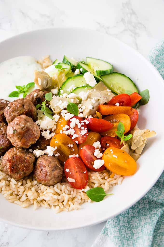 These Greek chicken meatball bowls are a quick weeknight dinner bursting with Mediterranean flavours of lemon, garlic and oregano. The whole dinner is on the table in 30 minutes.