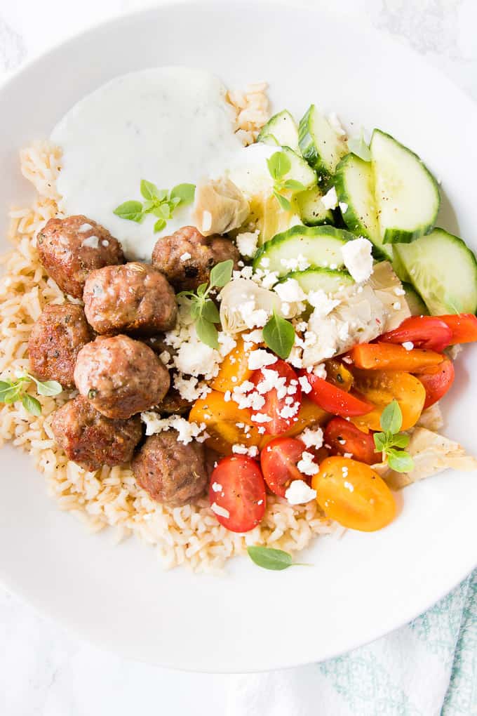 These Greek chicken meatball bowls are a quick weeknight dinner bursting with Mediterranean flavours of lemon, garlic and oregano. The whole dinner is on the table in 30 minutes.