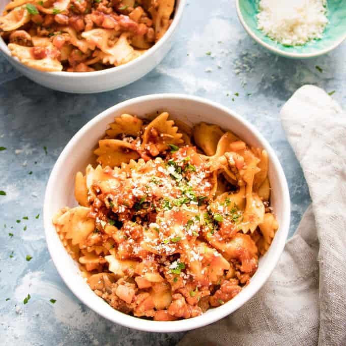 This simple bolognese sauce is a modern take on the cosy comfort classic. Rich meaty sauce loaded with herbs and spices and Vegetables. It skips the long simmer and comes together in under an hour.