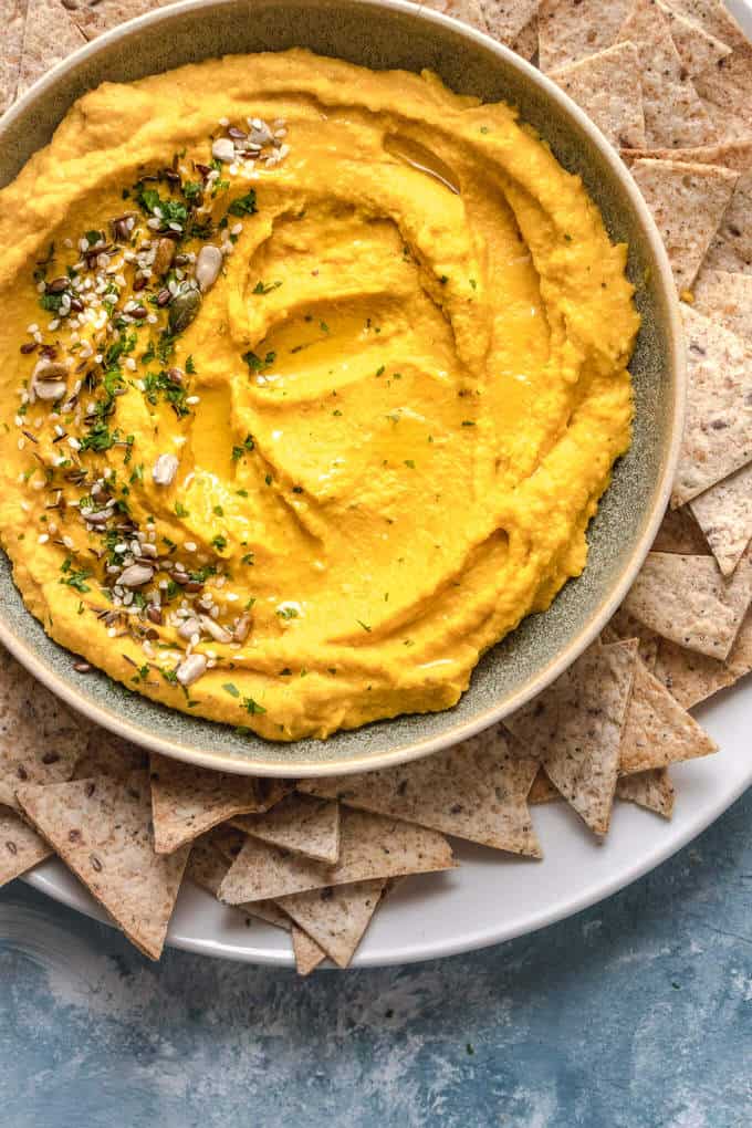 Protein packed roasted carrot hummus is the creamiest, fun twist on regular hummus. It's super simple, packed with protein and a creamy dreamy snack time dip or sauce to have on your fave foods. A perfect addition to any sandwich, wrap or crudité platter.