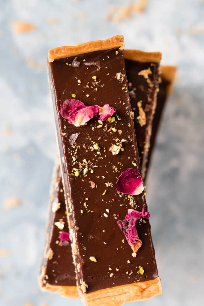 This is the creamiest dreamiest chocolate truffle tart that you will ever eat. Dark smooth chocolate, in a crispy flaky crust, topped with hazelnuts.
