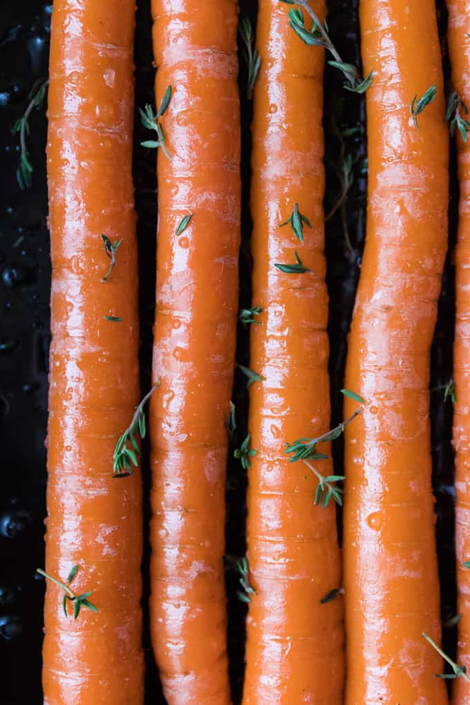 Trimmed carrots on a roasting tray ready to be glazed.