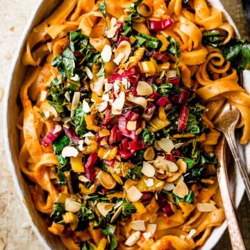 Roasted red pepper pasta with winter greens in a bowl.