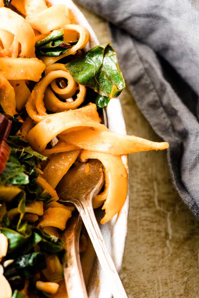 This tuscan pasta feast is a quick way to get extra veggies. Rich roasted red pepper pasta with bitter wilted Italian green and toasted almonds.