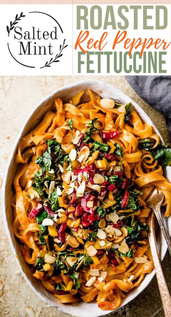 Creamy red pepper pasta with greens and text overlay.