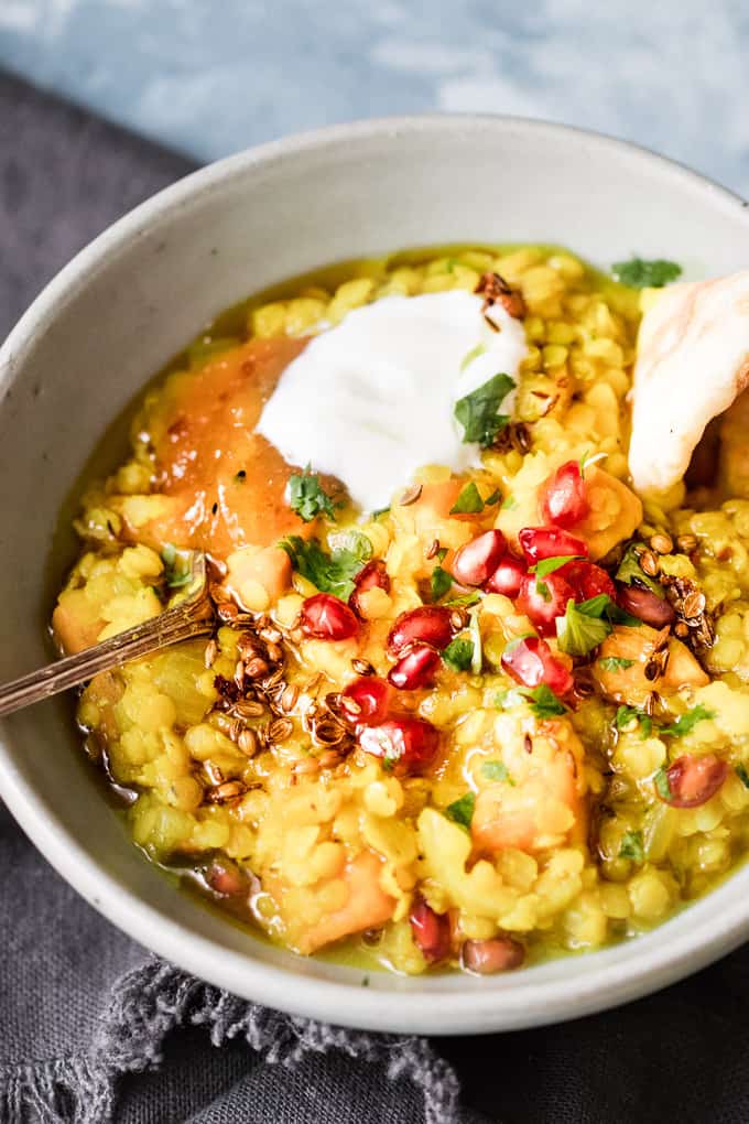 Comforting and fragrant Indian sweet potato red lentil dal soup, packed with sweet potatoes, topped with juicy pomegranate arils and fragrant cilantro.