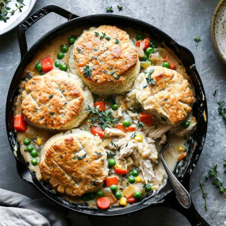 Chicken pot pie with biscuits in a skillet.