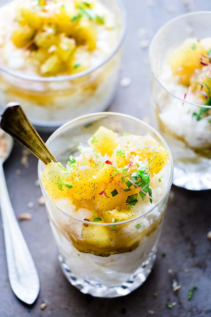 This warm and creamy coconut rice pudding is a the perfect comfort dessert. It's made with fragrant kafir lime and coconut milk. Topped with vanilla and brown sugar pineapple. It's family friendly and vegan. Ready in 25 minutes.