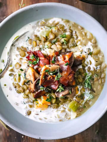 Creamy lentils with bacon and thyme in a bowl.