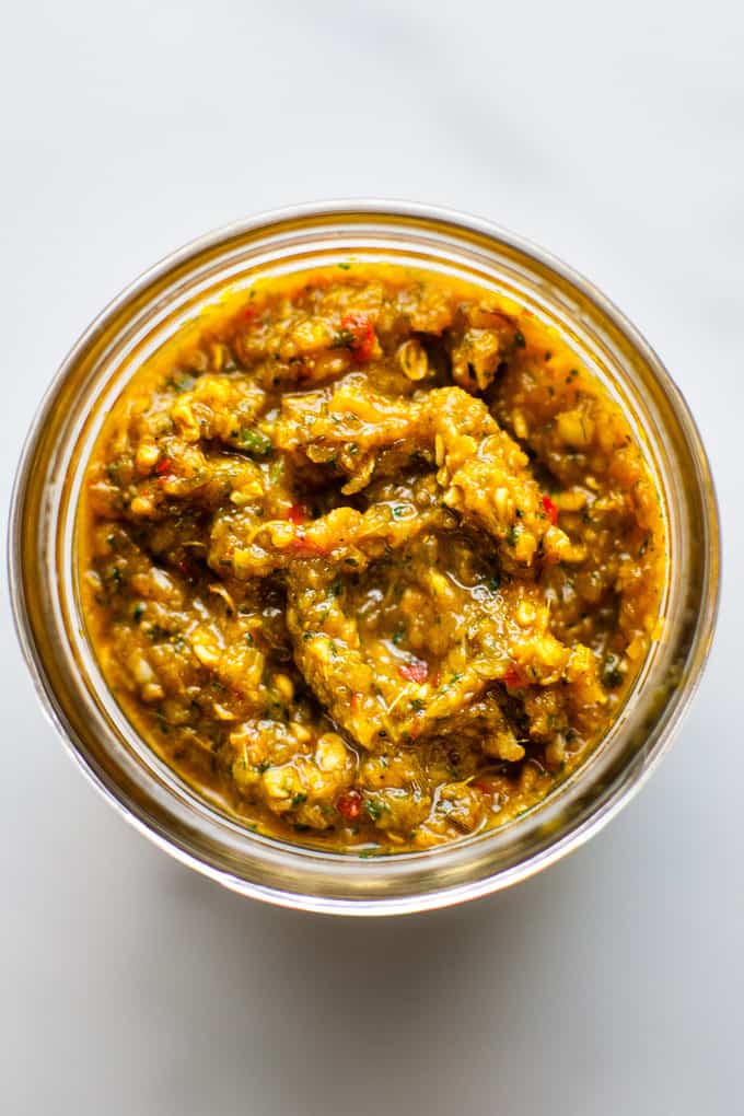 Jar of Thai yellow curry paste on a white background.