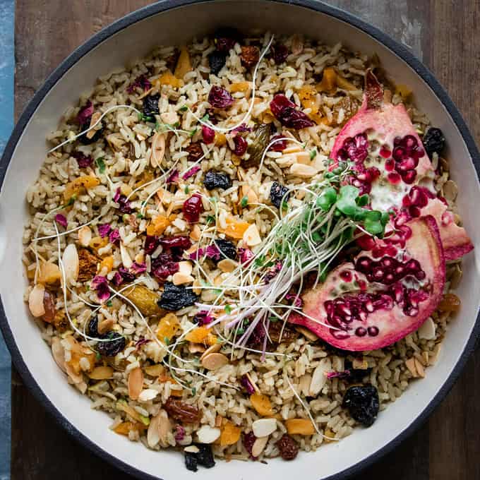 This simple Moroccan rice pilaf is a one pot rice wonder. Fragrant with spices, nuts and dried fruit it's simple enough for weeknights and hearty enough to be dinner on it's own. A totally vegan, whole grain dish made with brown rice and spices.  #plantbased #moroccan #rice