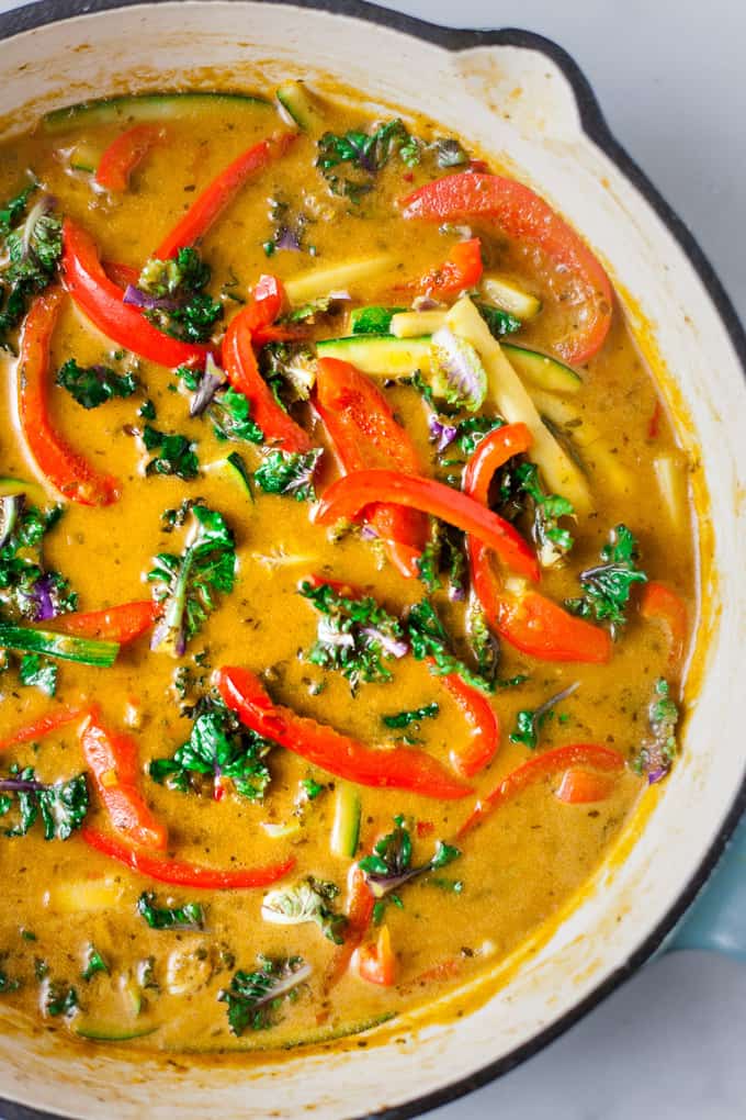 Thai red curry sauce and veggies in a pan. 