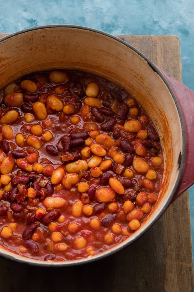This smokey Moroccan 3 bean stew is hearty and warming. A protein packed vegan bowl of tomatoes, spices and beans brought together with spicy and rosy Harissa sauce. It's a 15 minute vegan dinner perfect for cold nights.