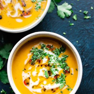 Creamy sweet potato coconut soup with herbs.