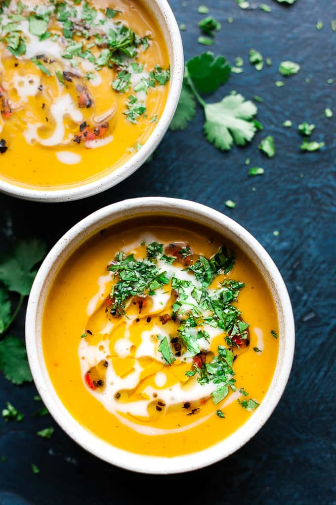 Over head photo of sweet potato soup with cilantro and coconut milk.