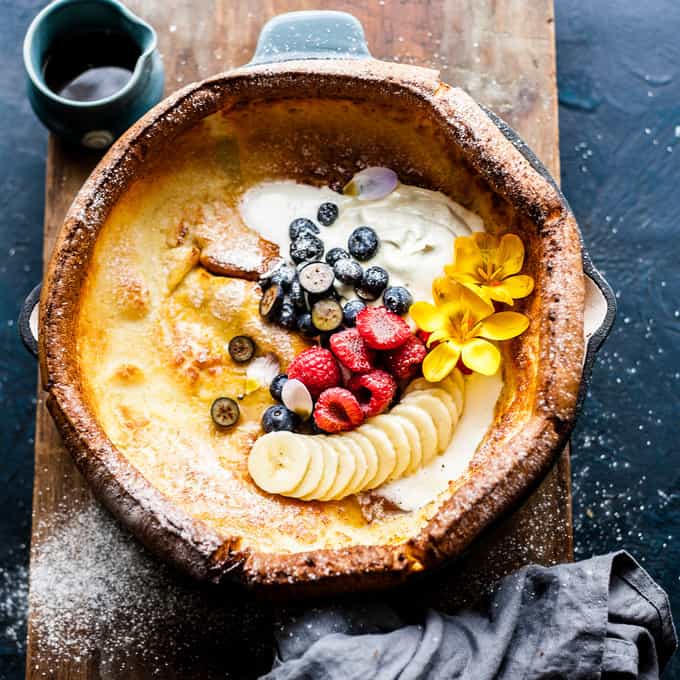 Pancake in Pan with fruit and cream.