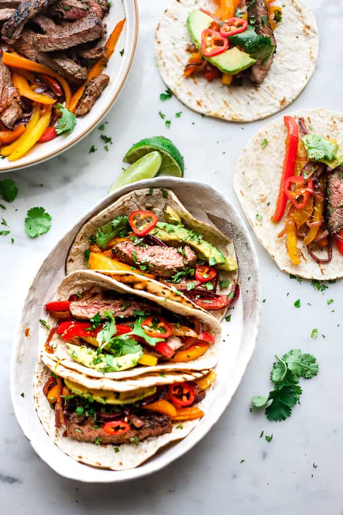 beef fajitas in a bowl with peppers and avocado