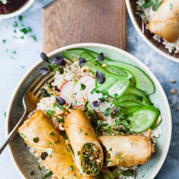 Vegetarian Spring Rolls in a bowl with rice and vegetables.