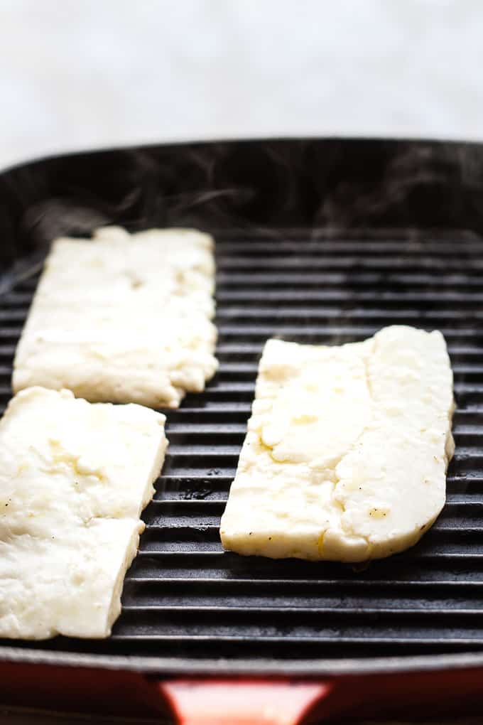 Sliced halloumi in a grill pan.