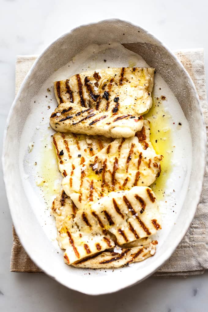 Grilled halloumi in a bowl with olive oil