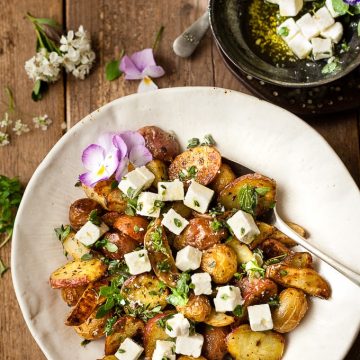Greek Roast Potatoes with feta in a bowl.