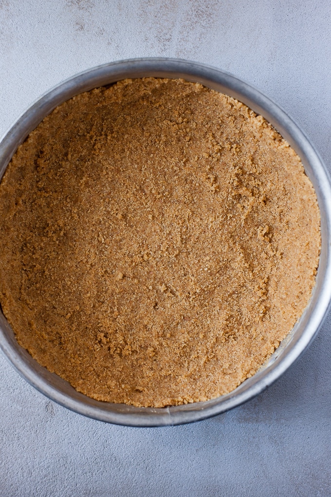 Graham cracker crust in a springform pan for cheesecake.