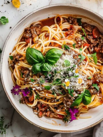 Easy summer bolognese pasta with basil in a bowl.