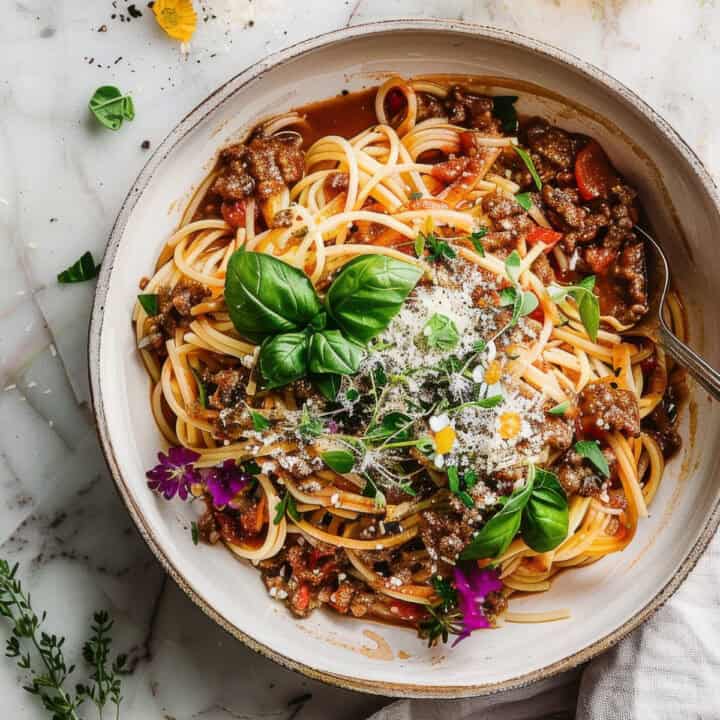 Easy summer bolognese pasta with basil in a bowl.