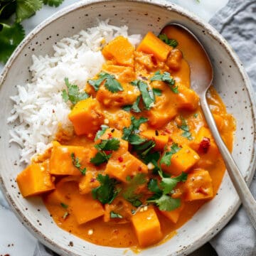 Easy vegetarian pumpkin curry with coconut milk in a white bowl.