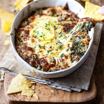 Hot Spinach Dip in a dish with chips.
