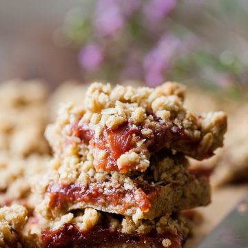 Stack of spiced plum crumble bars.
