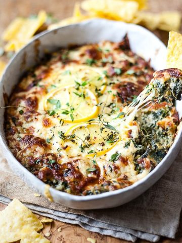 Spinach and artichoke dip in a white dish.