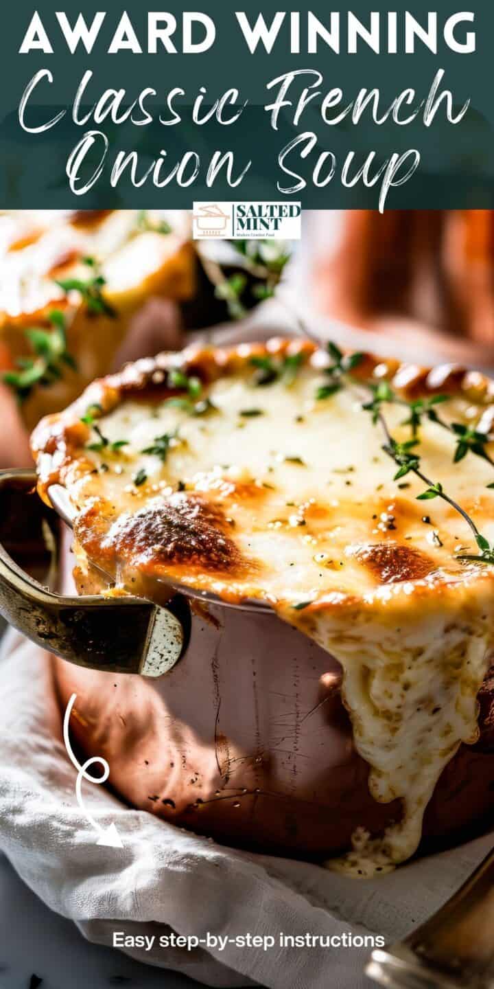 French onion soup with cheese and thyme leaves on a white table.