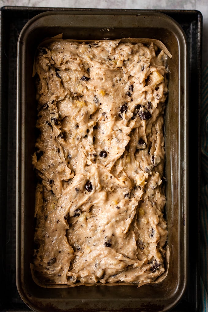 Sour cream chocolate chip banana bread in the lined loaf tin.