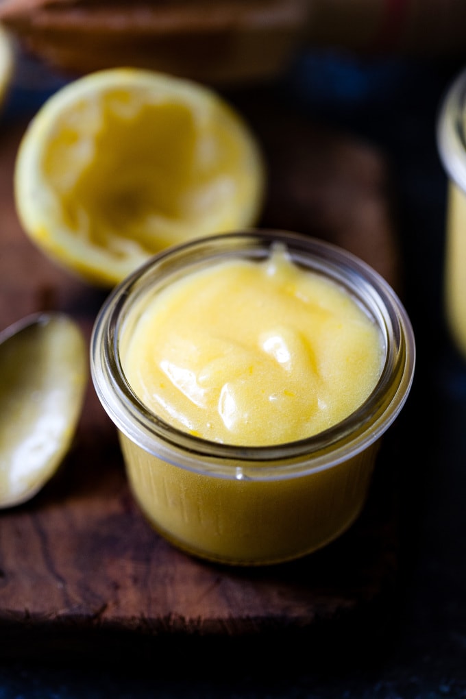 close up of lemon curd in a small jar.