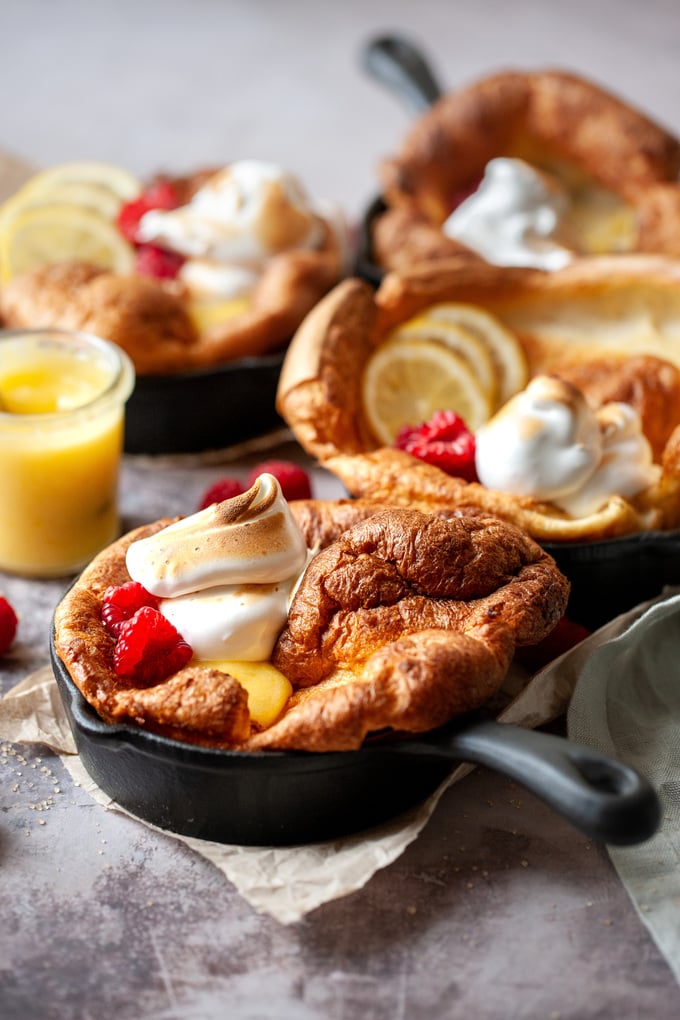 Lemon Meringue Dutch Baby in a cast iron skillet.