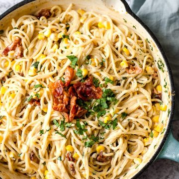 Skillet of creamy one pot pasta with corn and bacon.