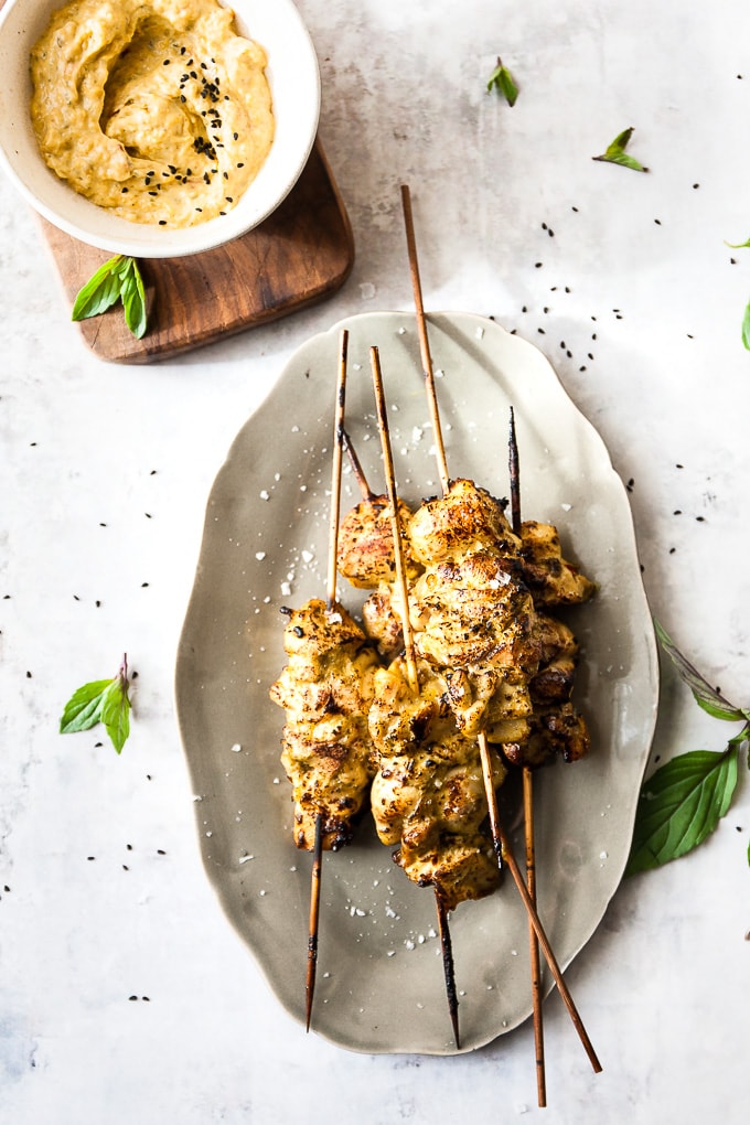 Oven grilled chicken skewers on a grey plate