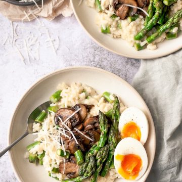 2 Bowls of asparagus risotto with soft boiled eggs.