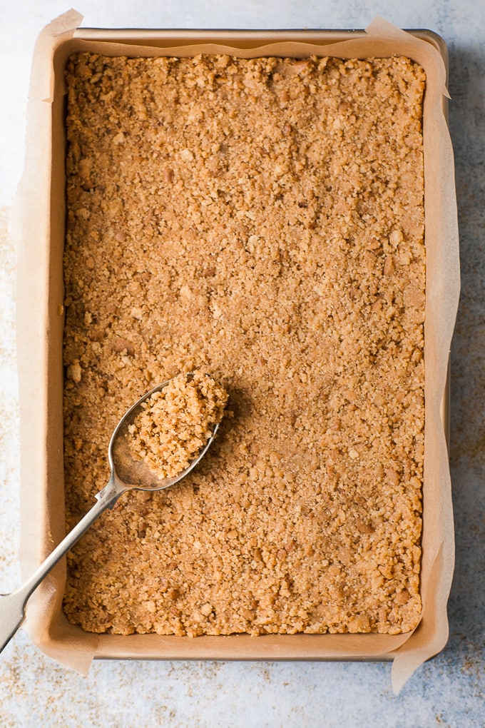 Cheesecake base pressed into a baking pan.