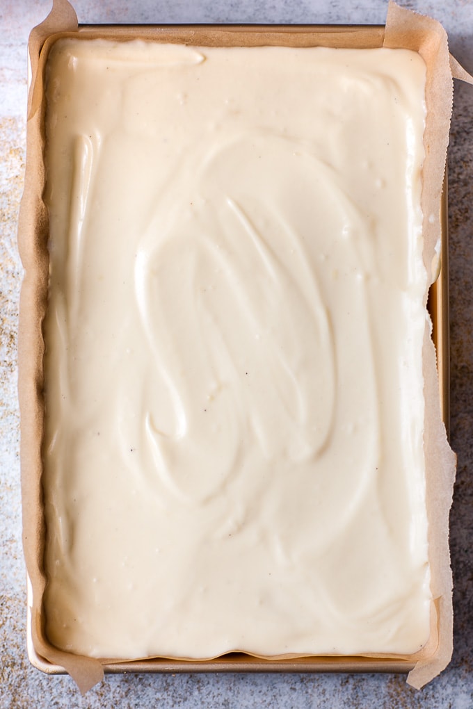 Cheesecake filling in a pan for making bars.