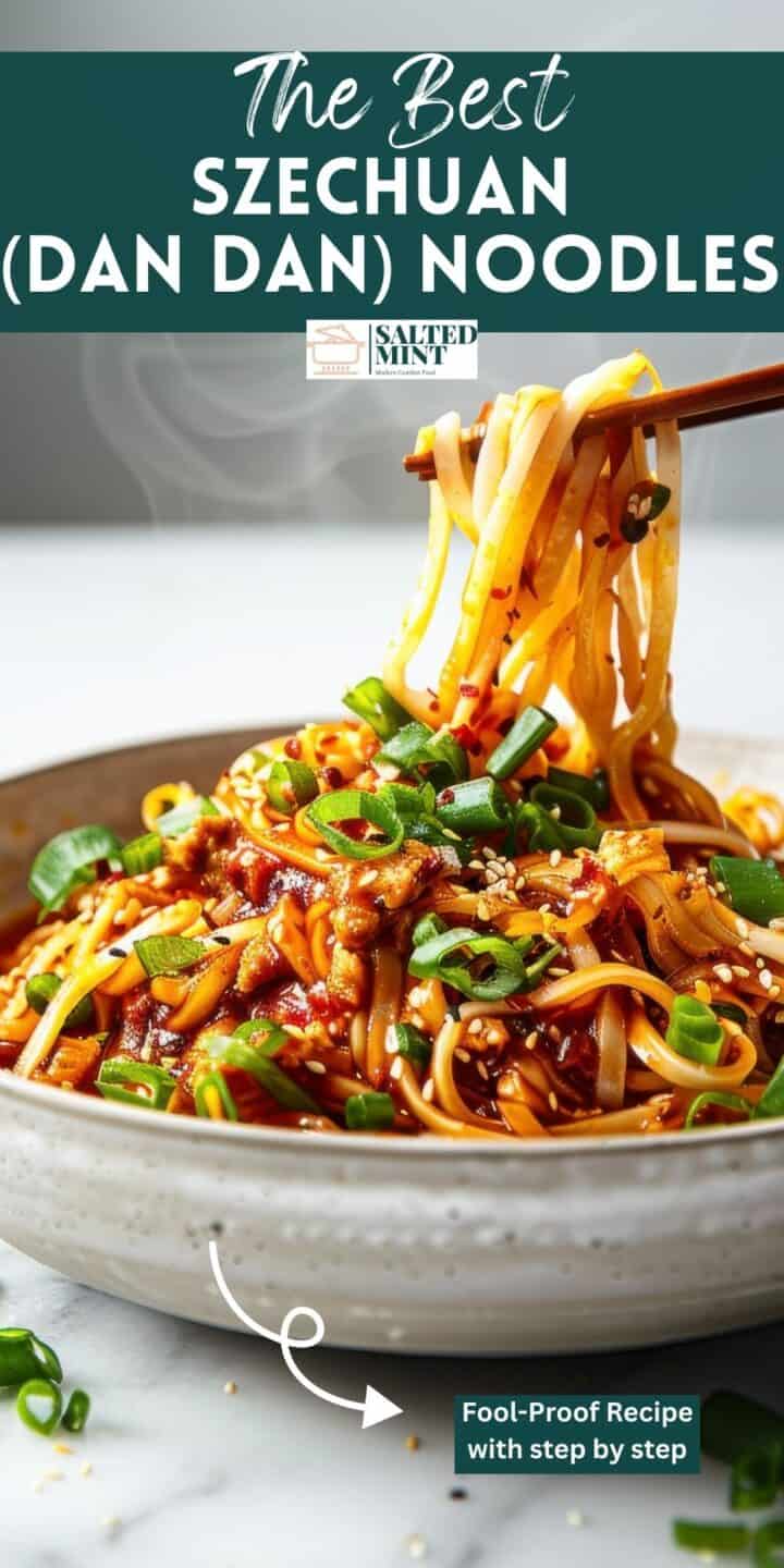 Spicy Szechuan noodles in a white bowl with green onions.