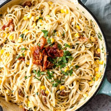 Skillet of creamy one-pot pasta with corn and bacon.