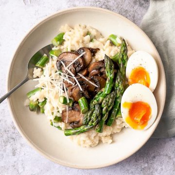 Asparagus risotto on a white table.