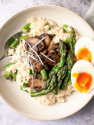Asparagus risotto on a white table.