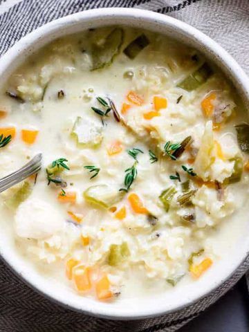 Creamy chicken soup with thyme leaves.