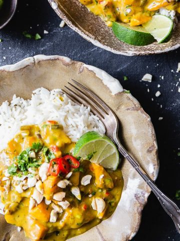 Creamy pumpkin curry with rice and limes.