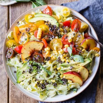 Pasta salad with peaches and a green basil dressing.