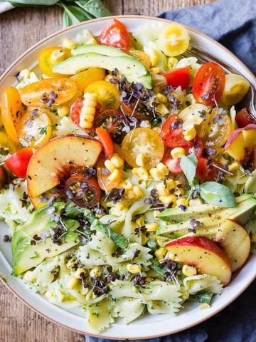 Pasta salad with peaches and a green basil dressing.