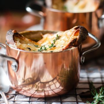 French onion soup with thyme leaves.